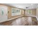 Bright living room with laminate floors, large windows, and a ceiling fan at 1854 Shadydale Se Ave, Atlanta, GA 30315