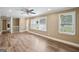 Spacious living room with laminate floors, large windows, and a ceiling fan at 1854 Shadydale Se Ave, Atlanta, GA 30315
