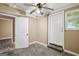A room featuring tile flooring, a ceiling fan, and two exterior door access points at 1854 Shadydale Se Ave, Atlanta, GA 30315