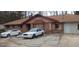 Cozy single-story brick home featuring a front yard with a driveway and a light brown roof at 1058 Viking Dr, Stone Mountain, GA 30083