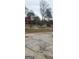 Spacious front yard surrounded by mature trees and the red house in the background at 1058 Viking Dr, Stone Mountain, GA 30083