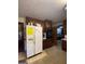 Outdated kitchen with dark wood cabinets and a white refrigerator at 1058 Viking Dr, Stone Mountain, GA 30083
