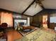 Living room with wood walls, a fireplace, and a ceiling fan at 1058 Viking Dr, Stone Mountain, GA 30083