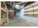 Unfinished basement with exposed ceiling, wooden shelving and plywood door at 105 Providence Ct, Carrollton, GA 30116