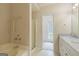 Primary bathroom with white cabinets and vanity, and a shower at 105 Providence Ct, Carrollton, GA 30116