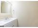 Half bath featuring a vanity with white cabinet, sink, and mirror at 105 Providence Ct, Carrollton, GA 30116