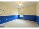 Bedroom with blue accent wall features neutral carpet, ceiling fan, and natural light at 105 Providence Ct, Carrollton, GA 30116