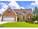 Charming two-story home featuring a brick and siding exterior, manicured lawn and two-car garage at 105 Providence Ct, Carrollton, GA 30116
