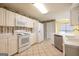 Classic white kitchen with a tile floor, ample counter space, and modern appliances at 105 Providence Ct, Carrollton, GA 30116