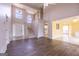 Spacious living room with hardwood floors, a grand staircase, and abundant natural light at 105 Providence Ct, Carrollton, GA 30116
