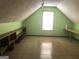 A spacious attic featuring tile floors, open shelving, light green walls, and natural light at 1744 Campbell Rd, Covington, GA 30014