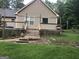 Back of home showcasing a wooden deck, vinyl siding, and lush green lawn at 1744 Campbell Rd, Covington, GA 30014