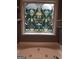 Bathroom features a tub with a decorative floral design window at 1744 Campbell Rd, Covington, GA 30014