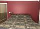 Bedroom features a wooden headboard and a bed with patterned comforter against a red wall at 1744 Campbell Rd, Covington, GA 30014