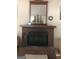Brick fireplace with wood mantel and decorative model ship at 1744 Campbell Rd, Covington, GA 30014