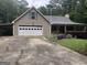 Charming single-story home featuring a two-car garage, covered porch, and a well-maintained landscaped yard at 1744 Campbell Rd, Covington, GA 30014