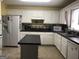 Bright kitchen featuring white cabinets, modern appliances, and a center island at 1744 Campbell Rd, Covington, GA 30014