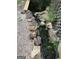A peaceful outdoor pond featuring flowing water, natural stone, and lush landscaping at 1744 Campbell Rd, Covington, GA 30014