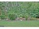 Beautiful backyard featuring meticulously landscaped garden beds with vibrant plants and greenery at 323 Newfield Way, Peachtree City, GA 30269