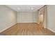 Expansive basement area featuring neutral walls, drop ceiling, wood-look flooring and a curtained doorway at 323 Newfield Way, Peachtree City, GA 30269