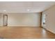 Open basement featuring wood-look floors, white drop ceiling, and a door to the exterior at 323 Newfield Way, Peachtree City, GA 30269