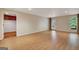 Spacious basement area with wood-look floors, drop ceiling, and a door with access to the backyard at 323 Newfield Way, Peachtree City, GA 30269