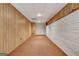Unfinished basement offers potential with wood paneling and white-painted brick walls at 323 Newfield Way, Peachtree City, GA 30269
