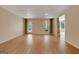 Open basement floor plan with wood-look flooring, a drop ceiling, a door to the outside and a window at 323 Newfield Way, Peachtree City, GA 30269