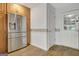 Modern kitchen with stainless steel refrigerator and door to the backyard at 323 Newfield Way, Peachtree City, GA 30269