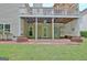 Covered outdoor patio with brick accents, a door, and storage, ideal for entertaining at 323 Newfield Way, Peachtree City, GA 30269