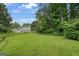 Extensive backyard with lush green grass, trees, and the back of the house in the background at 3570 Keels Ln, Atlanta, GA 30349