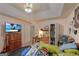Cluttered bedroom with a ceiling fan, dresser, and natural light from the window at 3570 Keels Ln, Atlanta, GA 30349