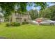 Two-story home with a well-maintained lawn and mature trees in a suburban setting with two parked cars at 3570 Keels Ln, Atlanta, GA 30349