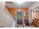 Inviting foyer featuring a wood front door, staircase and patterned tile flooring at 3570 Keels Ln, Atlanta, GA 30349