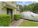 Close up of the front door and landscaped yard with a view of cars parked in the driveway at 3570 Keels Ln, Atlanta, GA 30349