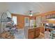 Spacious kitchen with wood cabinets, island with barstools and view into a back door at 3570 Keels Ln, Atlanta, GA 30349