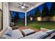 Cozy covered back patio with outdoor seating, overlooking a large, well-maintained backyard at night at 1102 Maybeck Way, Peachtree City, GA 30269