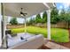 Inviting covered back patio with ceiling fan and comfortable seating overlooking a large, fenced backyard at 1102 Maybeck Way, Peachtree City, GA 30269