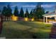 Expansive backyard with lush green grass, mature trees, and a cozy covered patio at 1102 Maybeck Way, Peachtree City, GA 30269