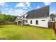 Spacious backyard featuring a well-maintained lawn, a covered patio, and a wood privacy fence at 1102 Maybeck Way, Peachtree City, GA 30269