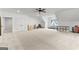 Large bonus room with carpet, neutral walls, ceiling fan, and plenty of space for activities and storage at 1102 Maybeck Way, Peachtree City, GA 30269