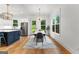 The stylish dining area features a modern light fixture, backyard views, and is conveniently located near the kitchen at 1102 Maybeck Way, Peachtree City, GA 30269