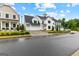 Beautiful two-story home with a white exterior, well-manicured lawn, and a three-car garage at 1102 Maybeck Way, Peachtree City, GA 30269