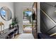 Elegant foyer with stylish decor, sleek console table, and a view of the home's inviting exterior at 1102 Maybeck Way, Peachtree City, GA 30269