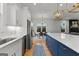 The kitchen features a stylish blue island with modern appliances and a view into the adjacent dining area at 1102 Maybeck Way, Peachtree City, GA 30269