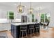 Elegant kitchen featuring a large island, stainless steel appliances, and an open layout connecting to the dining area at 1102 Maybeck Way, Peachtree City, GA 30269