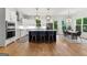 Open kitchen featuring an island with seating, stainless steel appliances, and a spacious dining area overlooking the backyard at 1102 Maybeck Way, Peachtree City, GA 30269