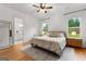 Serene main bedroom featuring hardwood floors and natural light from the two windows that overlook the backyard at 1102 Maybeck Way, Peachtree City, GA 30269
