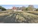 Expansive backyard featuring a brick home with screened-in porch, a shed, and mature trees at 395 W Mcintosh Rd, Brooks, GA 30205