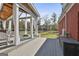 Charming backyard area with covered deck, white drapes, and expansive green lawn at 395 W Mcintosh Rd, Brooks, GA 30205